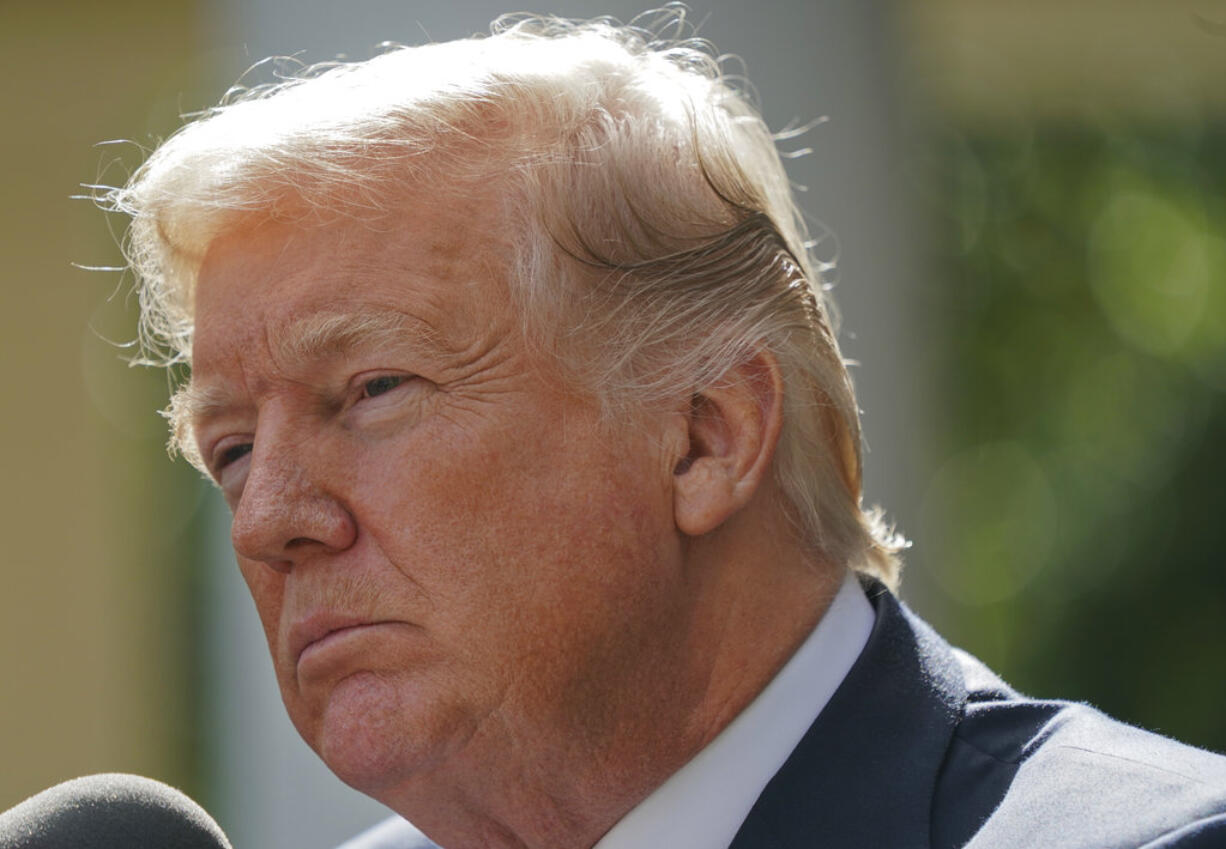 In this Oct. 16, 2017, photo, President Donald Trump listens to a questions prior to speaking to members of the media in the Rose Garden of the White House. Trump is proving to be an erratic trading partner as he kicks thorny policy issues to Congress and then sends conflicting signals about what he really wants. His rapid backpedal on a short-term health care fix this week is the latest example to leave Republicans and Democrats alike scratching their heads.