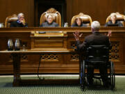 Tom Ahearne, lower right, the lead attorney in a lawsuit against the state of Washington regarding the funding of education, speaks Tuesday, Oct. 24, 2017, during a Washington Supreme Court hearing in Olympia, Wash. The hearing was held to determine if Washington state has complied with a court mandate to fully fund the state's basic education system. (AP Photo/Ted S.