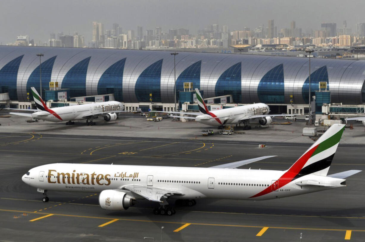 FILE - In this Wednesday, March 22, 2017 file photo, an Emirates plane taxis to a gate at Dubai International Airport at Dubai International Airport in Dubai, United Arab Emirates. Long-haul carrier Emirates says it is starting new screening procedures for U.S.-bound passengers following it receiving "new security guidelines" from American authorities.