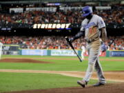 Los Angeles Dodgers’ Yasiel Puig walks to the dugout after striking out against the Houston Astros during the ninth inning of Game 3 of baseball’s World Series Friday, Oct. 27, 2017, in Houston.