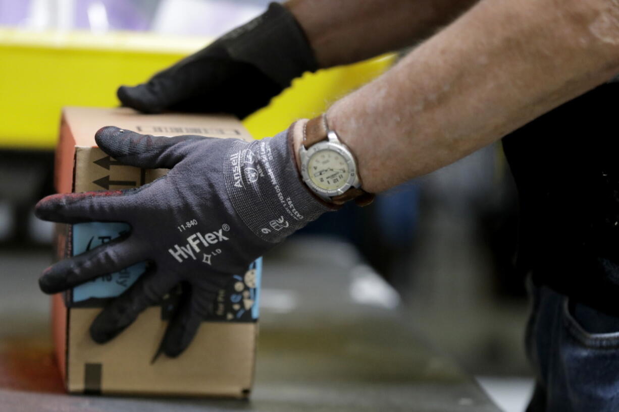 An employee packages a product at the Amazon Fulfillment center in Robbinsville Township, N.J.