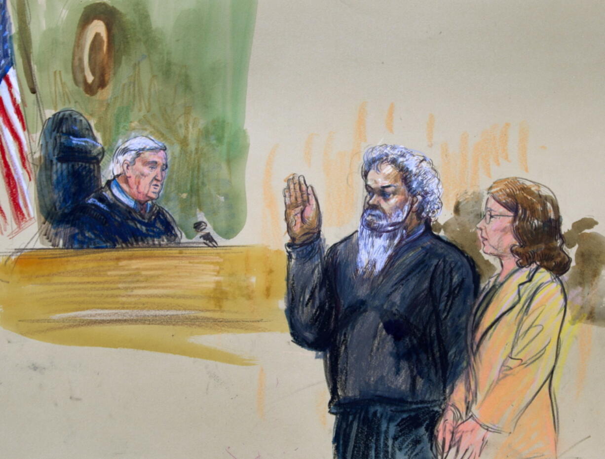 United States Magistrate, Judge John Facciola, swearing in the defendant, Libyan militant Ahmed Abu Khattala, wearing a headphone, as his attorney Michelle Peterson watches during a hearing at the federal U.S. District Court in Washington. The trial of Khattala, the Libyan militant accused of being the mastermind of the 2012 Benghazi attacks is scheduled to begin on Oct. 2, 2017.