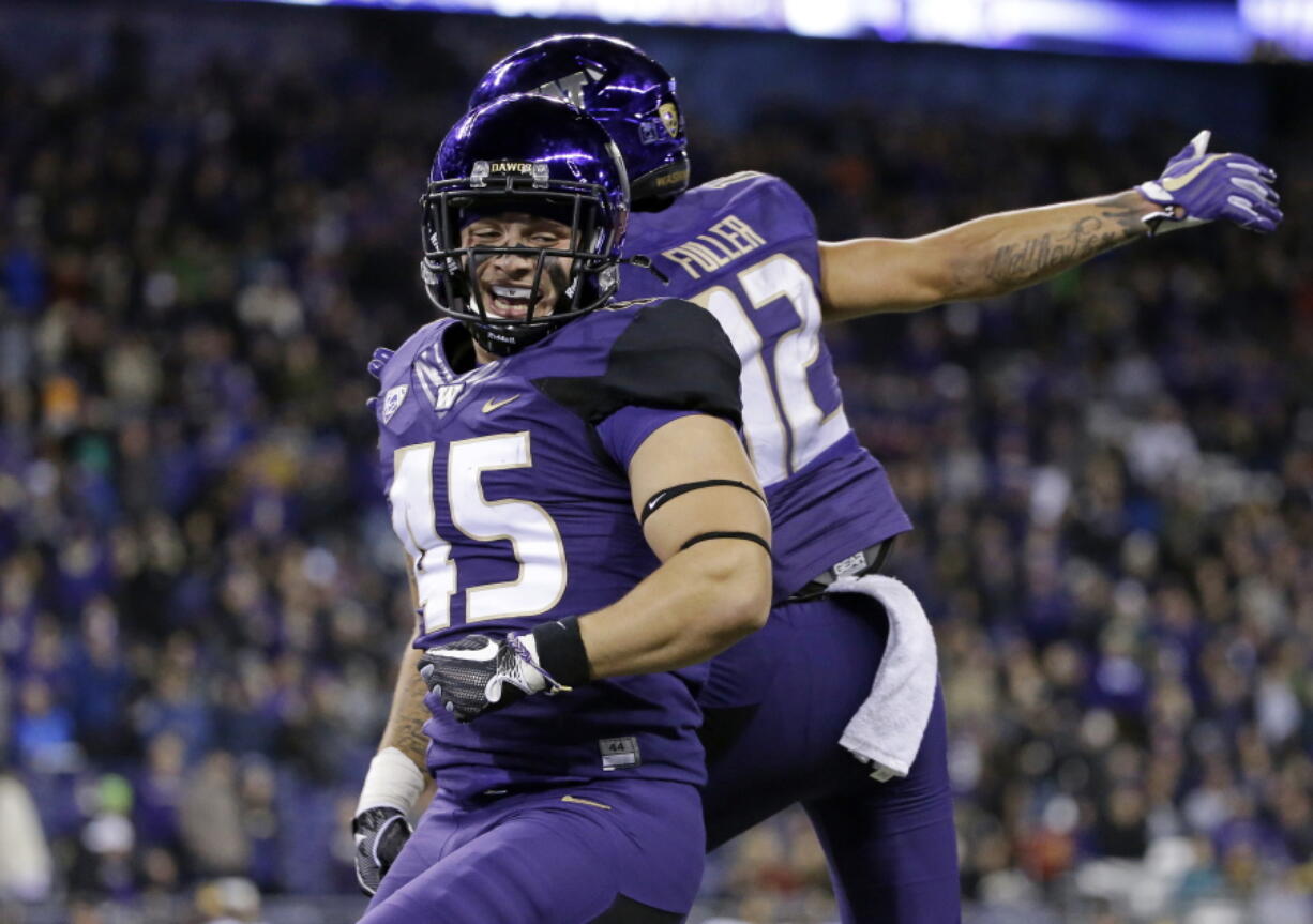 Washington's Jusstis Warren celebrates his touchdown against California with Aaron Fuller in the second half of an NCAA college football game Saturday, Oct. 7, 2017, in Seattle.