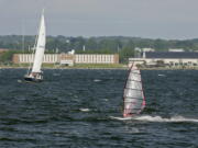 FILE - In this June 12, 2007, file photo, a windsurfer and people aboard a sailboat enjoy the strong winds of Narragansett Bay off the coast of Newport, R.I. The Environmental Protection Agency has canceled the appearance of three scientists at an event on Monday, Oct. 23, 2017, in Rhode Island about a report, which deals in part with climate change. The event is designed to draw attention to the health of the Narragansett Bay.