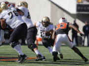 Colorado running back Phillip Lindsay (23) looks for an opening in the Oregon State defense during the first half an NCAA college football game, in Corvallis, Ore., Saturday, Oct. 14, 2017. (AP Photo/Timothy J.