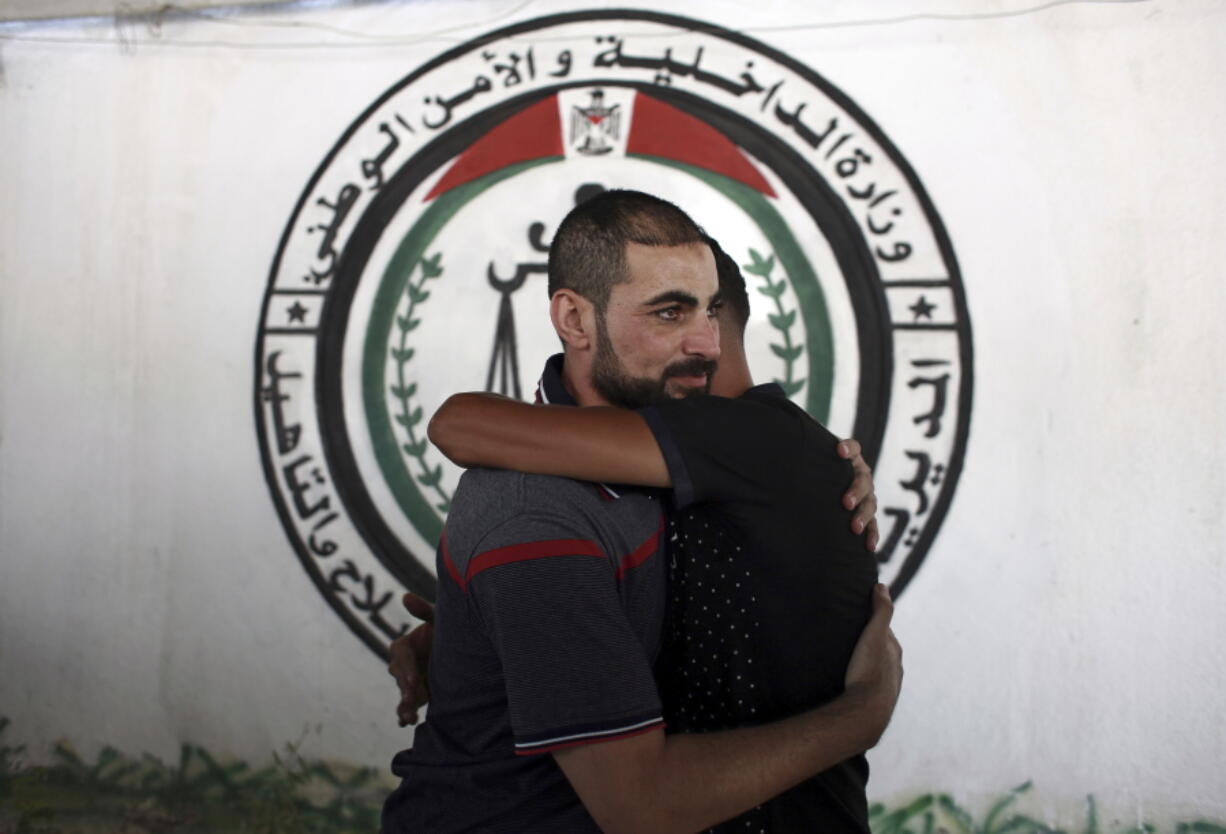 A Palestinian Fatah member receives greetings after being released from a Hamas jail in front of the interior ministry, in Gaza City, Sunday. The Palestinian prime minister is set to lead a large delegation of Fatah officials traveling from the West Bank to Gaza on Monday in the most ambitious attempt to reconcile with the rival Hamas militant group after a 10-year rift that has left the Palestinians divided between two governments.