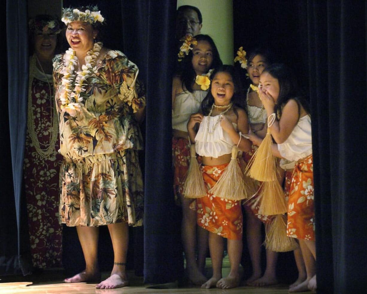 Deva Yamashiro, left, with the Kukui Foundation, and young students, from left to right: Bianca Finley, Reina Beth Phengthalangsy, Saya Fyock and Shelby Campbell break out laughing at selected audience members as they try their hand at hula dancing during the Otea finale in 2015. Yamashiro, or “Aunty Deva,” as she’s known to many, died Monday at the age of 62.