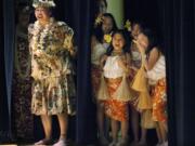 Deva Yamashiro, left, with the Kukui Foundation, and young students, from left to right: Bianca Finley, Reina Beth Phengthalangsy, Saya Fyock and Shelby Campbell break out laughing at selected audience members as they try their hand at hula dancing during the Otea finale in 2015. Yamashiro, or “Aunty Deva,” as she’s known to many, died Monday at the age of 62.