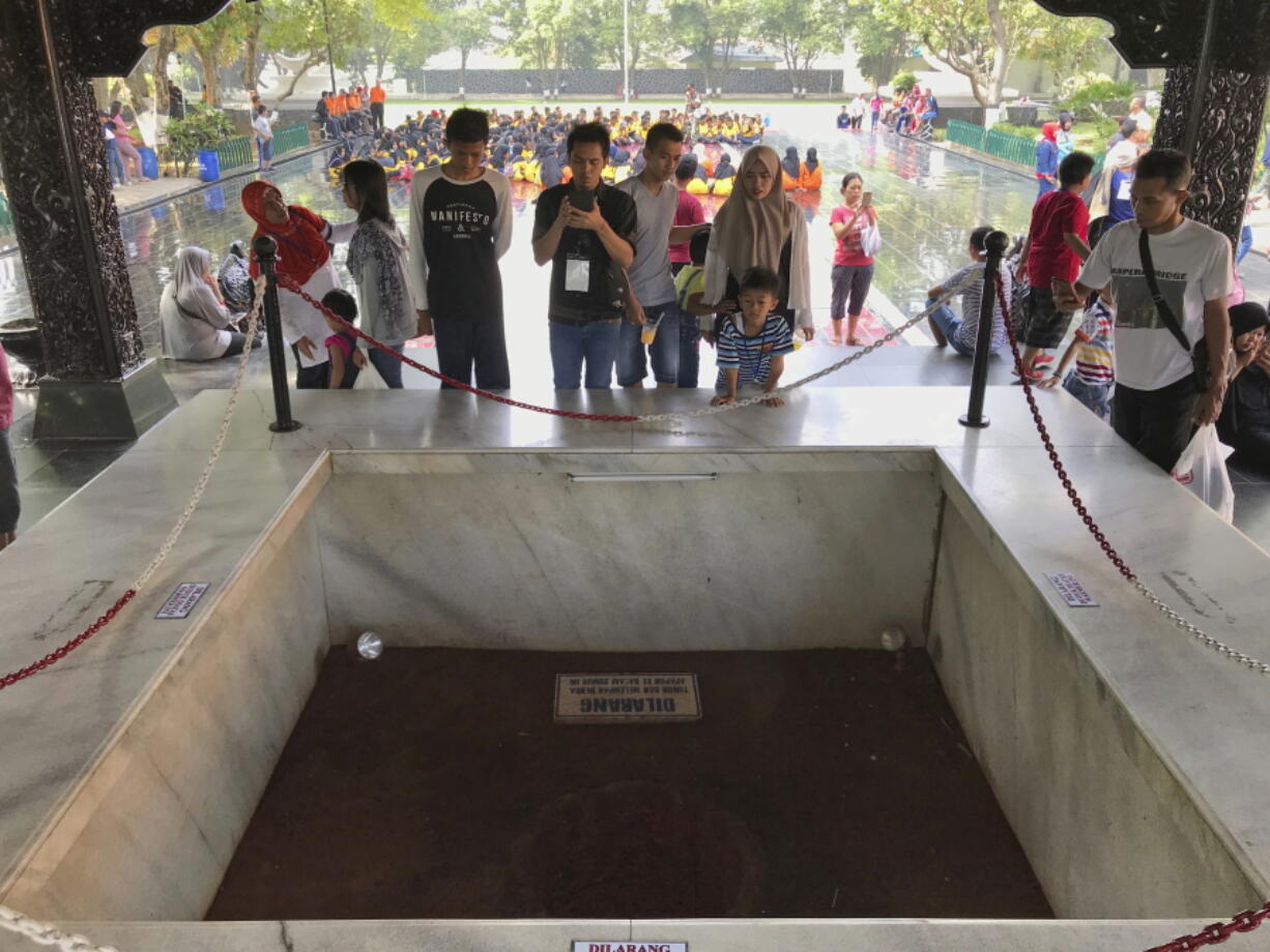 Visitors look at an old well where six Indonesian Army generals and a junior officer were buried in an abortive coup in 1965 that the military blamed on Indonesia’s Communist Party and subsequently led to the anti-communist purge in 1965-1966, at Pancasila Sakti Monument in Jakarta, Indonesia. Declassified files have revealed new details of American government knowledge and support of an Indonesian army extermination campaign that killed several hundred thousand civilians during anti-communist hysteria in the mid-1960s.