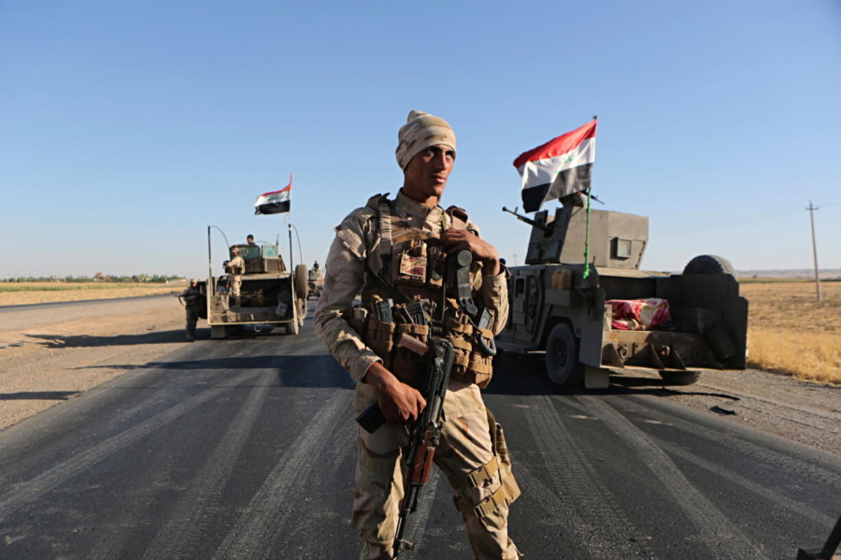 Iraqi security forces gather outside the Kurdish-held city of Altun Kupri on the outskirts of Irbil, Iraq. The U.S.-led coalition said Friday, Oct. 27, 2017 that a cease-fire has been reached between Baghdad and Iraq’s Kurdish minority, temporarily halting clashes that followed a controversial vote on Kurdish independence last month.