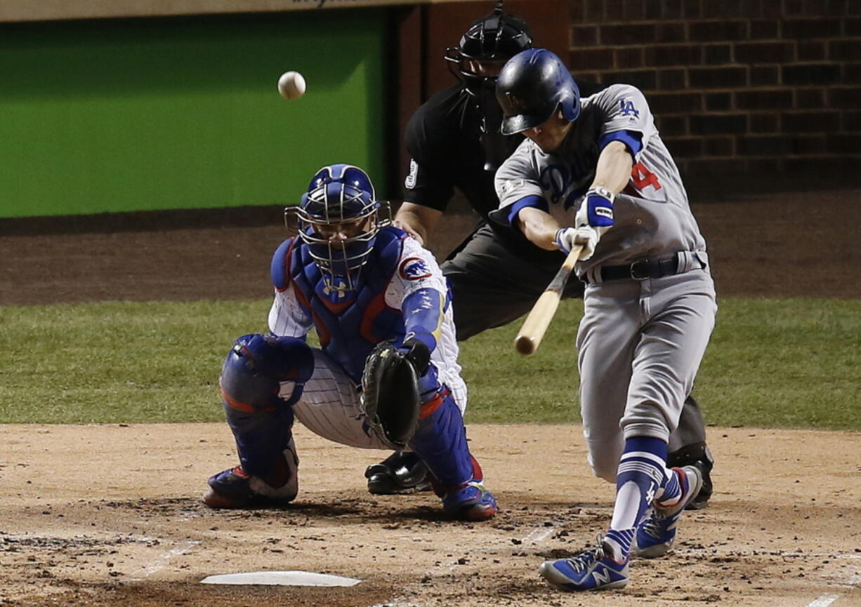 Los Angeles Dodgers’ Enrique Hernandez (14) hits a home run off Chicago Cubs starting pitcher Jose Quintana during the second inning of Game 5 of baseball’s National League Championship Series, Thursday, Oct. 19, 2017, in Chicago.