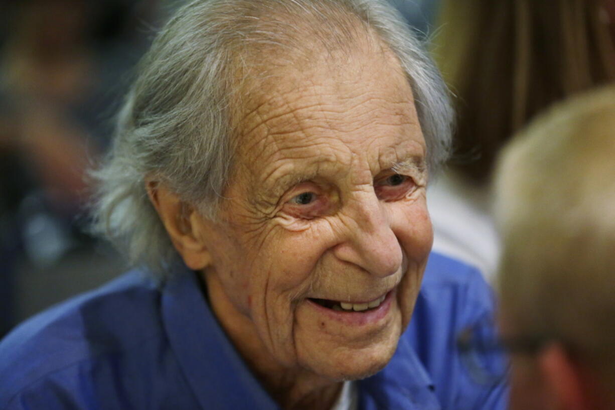 FILE - In this July 26, 2016, file photo, Fred Beckey, the legendary mountain climber, visits with guests during a promotional event for “Dirtbag: The Legend of Fred Beckey,” an upcoming documentary feature film about his life in Seattle. Beckey died on Monday, Oct. 30, 2017, according to Megan Bond, a close friend who managed his affairs. He was 94. (AP Photo/Ted S.