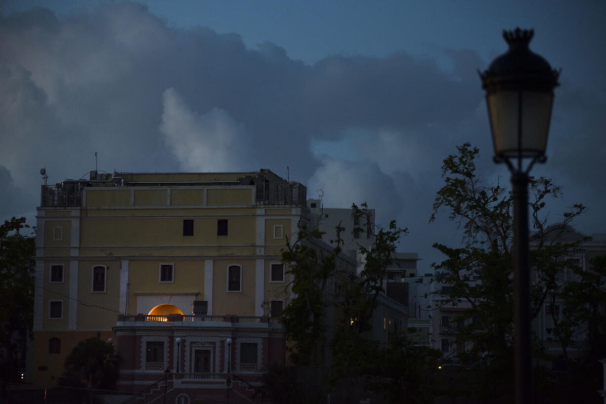 In this Friday, Oct. 20, 2017 photo, the streets of Old San Juan are dark after sunset one month after Hurricane Maria in San Juan, Puerto Rico. Tourism, a rare thriving sector on the island in a deep economic slump, is practically nonexistent a month after Hurricane Maria swept though.