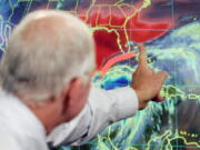 FILE - In this Oct. 19, 2005 file photo, Max Mayfield, the former director of the hurricane center (now retired), draws a line showing one of the possible trajectories of Hurricane Wilma in Miami. It’s not just this year. The monster hurricanes Harvey, Irma, Maria, Jose and now Lee that have raged across the Atlantic are contributing to what appears to be the most active period for major storms on record.