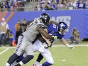 Seattle Seahawks' Sheldon Richardson, left, tackles New York Giants quarterback Eli Manning during the second half of an NFL football game, Sunday, Oct. 22, 2017, in East Rutherford, N.J.