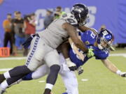 Seattle Seahawks’ Sheldon Richardson, left, tackles New York Giants quarterback Eli Manning during the second half of an NFL football game, Sunday, Oct. 22, 2017, in East Rutherford, N.J.