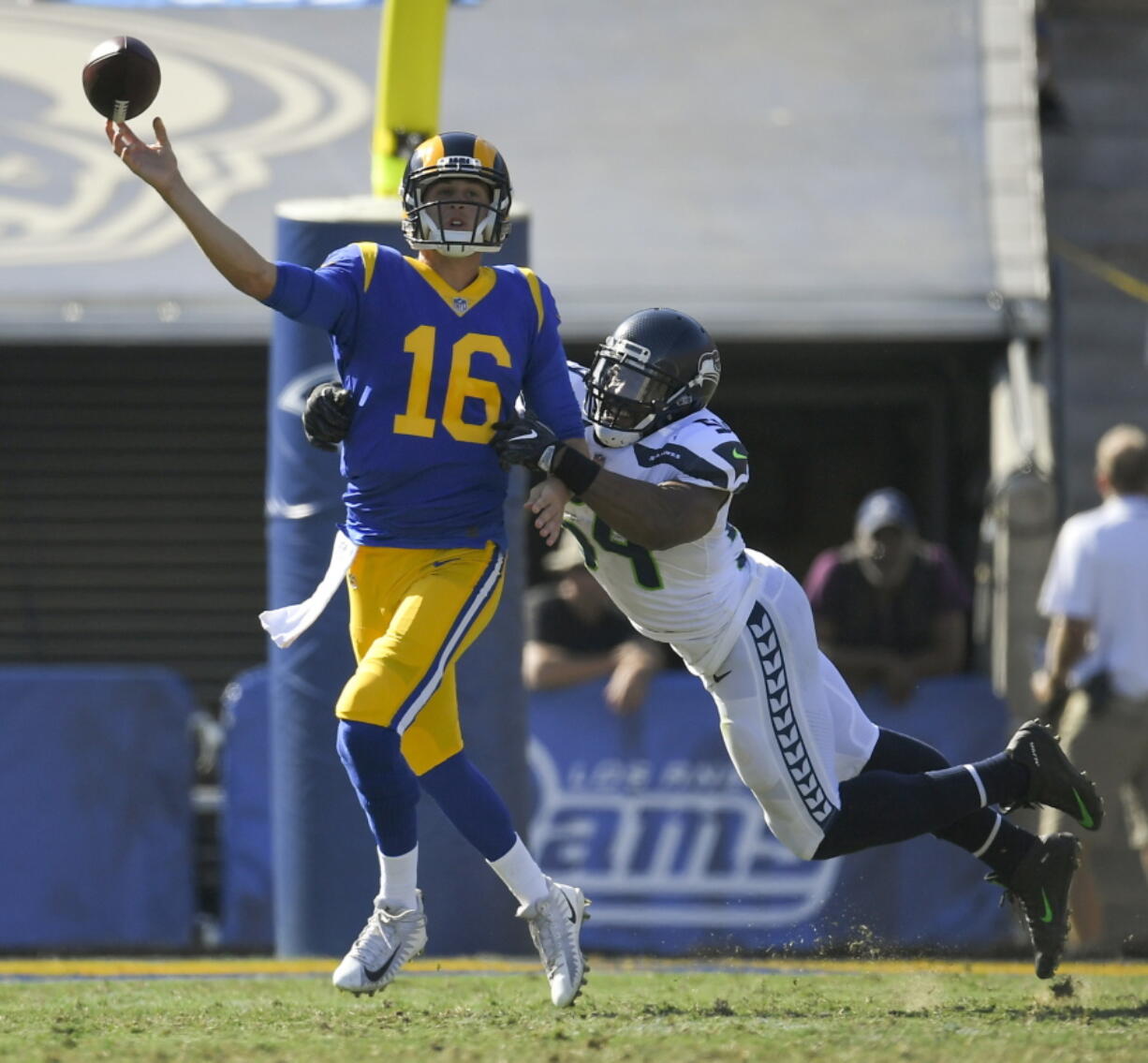 Los Angeles Rams quarterback Jared Goff, left, passes under pressure by Seattle Seahawks middle linebacker Bobby Wagner during the second half of an NFL football game Sunday, Oct. 8, 2017, in Los Angeles. (AP Photo/Mark J.