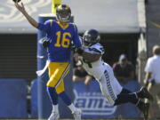 Los Angeles Rams quarterback Jared Goff, left, passes under pressure by Seattle Seahawks middle linebacker Bobby Wagner during the second half of an NFL football game Sunday, Oct. 8, 2017, in Los Angeles. (AP Photo/Mark J.