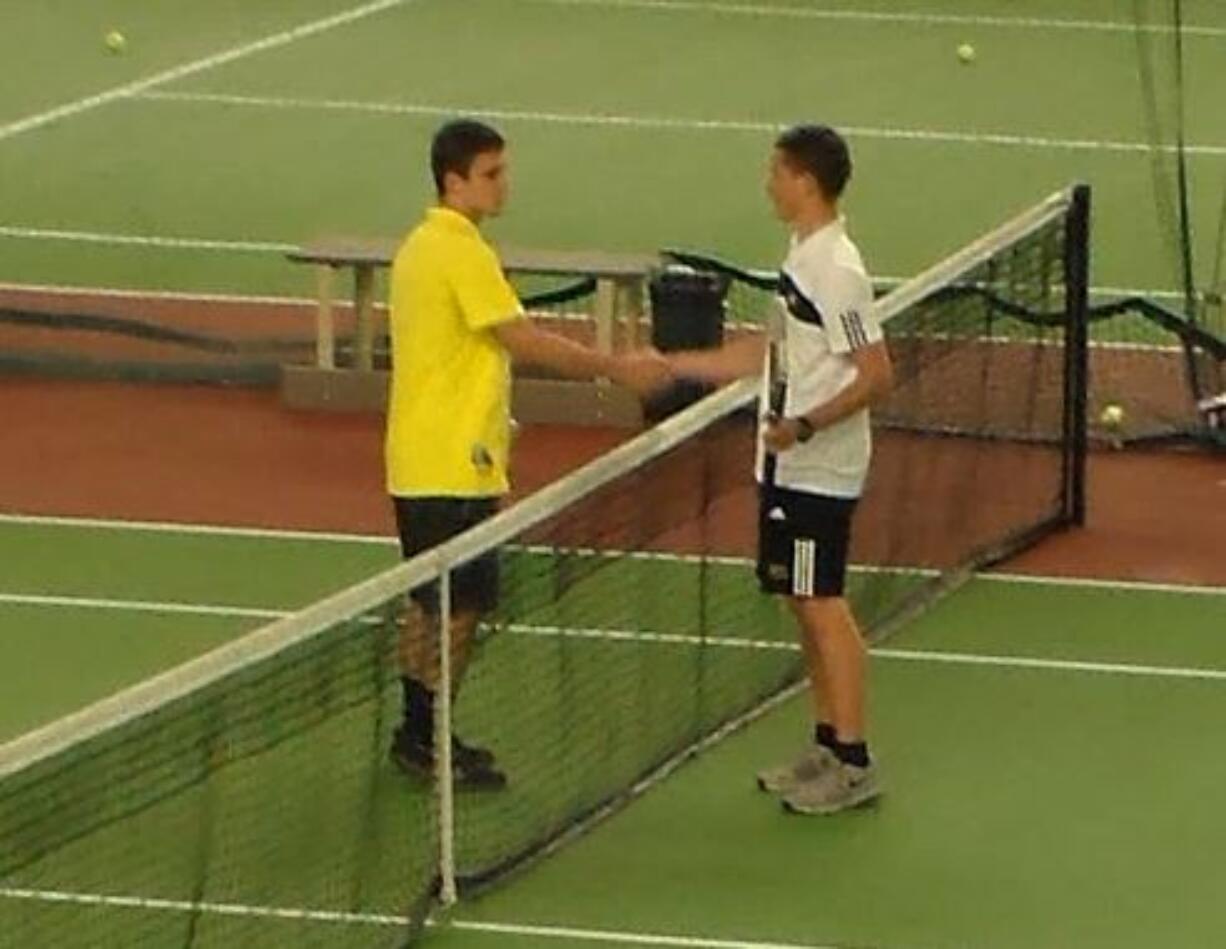 Andre Mertvyy (left) of Columbia River shakes hands with his brother, David Mertvyy of Hudson's Bay, after Andre beat David in a non-league match last Wednesday at Vancouver Tennis Center (Tim Martinez/The Columbian)