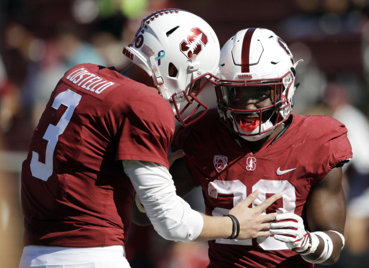 FILE - In this Sept. 30, 2017, file photo, Stanford running back Bryce Love, right, celebrate his rushing touchdown with teammate K.J. Costello during the third quarter of an NCAA college football game against Arizona State in Stanford, Calif. Heisman Trophy candidate Bryce Love will be a game-time decision for No. 20 Stanford against Oregon State on Thursday night.