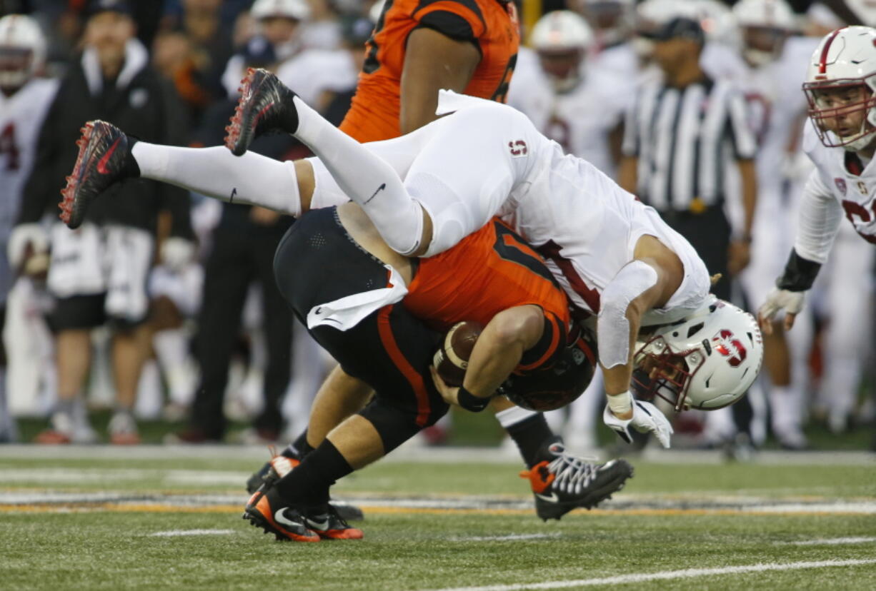 Stanford linebacker Jordan Perez, top, sacks Oregon State quarterback Darell Garretson, bottom, in the first half of an NCAA college football game, in Corvallis, Ore., Thursday, Oct. 26, 2017. (AP Photo/Timothy J.