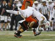 Stanford linebacker Jordan Perez, top, sacks Oregon State quarterback Darell Garretson, bottom, in the first half of an NCAA college football game, in Corvallis, Ore., Thursday, Oct. 26, 2017. (AP Photo/Timothy J.