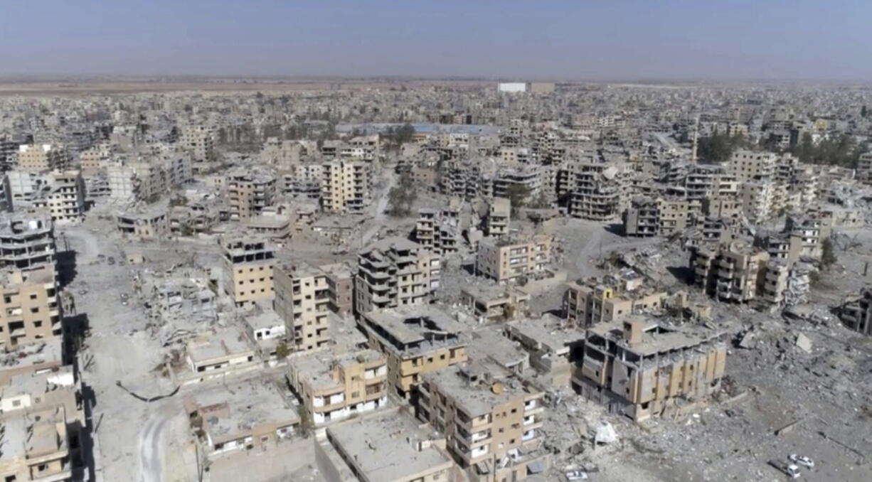 This Thursday, Oct. 19, 2017 frame grab made from drone video shows damaged buildings in Raqqa, Syria, two days after Syrian Democratic Forces said that military operations to oust the Islamic State group have ended and that their fighters have taken full control of the city.