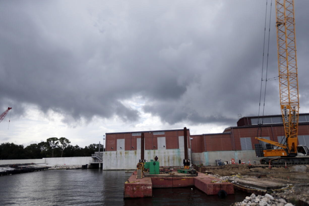 Rain clouds gather over a pumping station at Marconi Drive and lake Pontchartrain in New Orleans. Flood-weary New Orleans braced Thursday for the weekend arrival of Tropical Storm Nate, forecast to hit the area Sunday morning as a weak hurricane that could further test a city drainage system in which weaknesses were exposed during summer deluges.