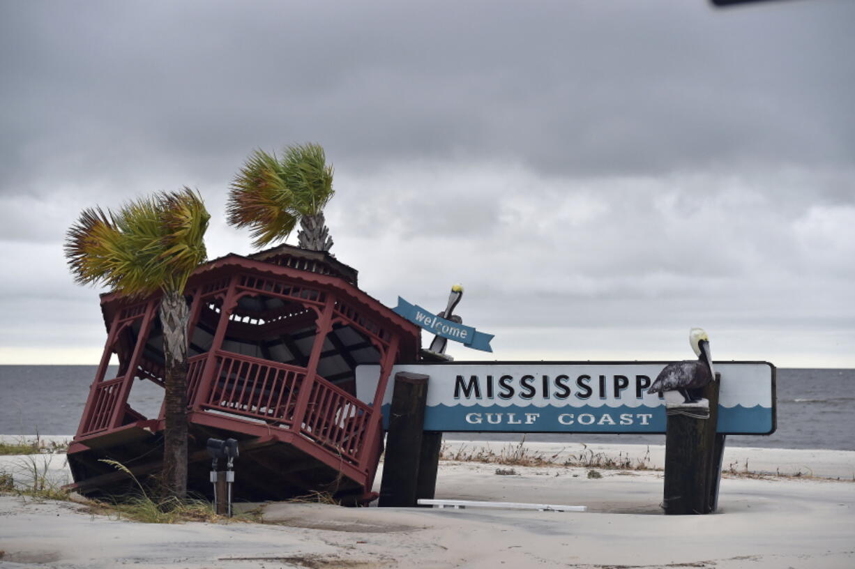 A gazebo is blown over the Mississippi Gulf Coast welcome sign in Gulfport, Miss. after Hurricane Nate made landfall.