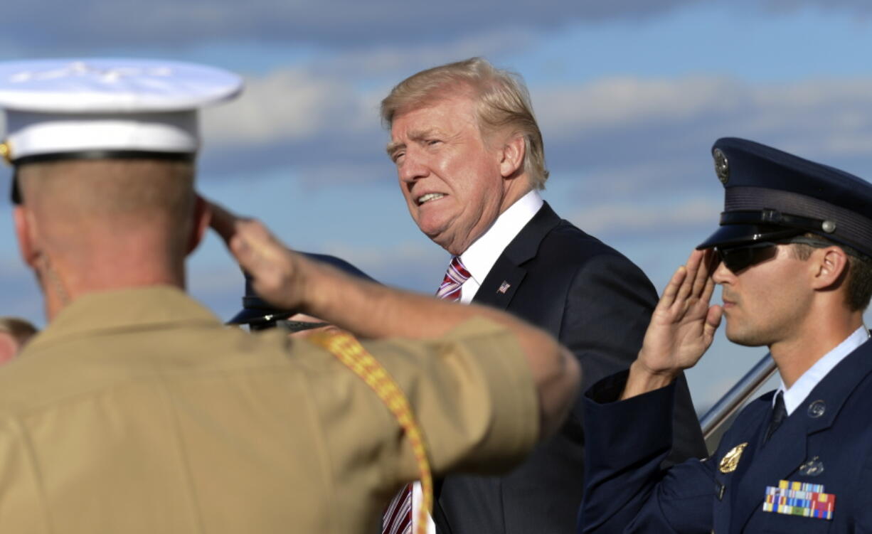 President Donald Trump walks down the steps of Air Force One at Morristown Municipal Airport in Morristown, N.J., on Friday. Trump is spending the weekend in Bedminster, N.J., at his golf club.