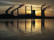 The coal-fired Plant Scherer, one of the nation’s top carbon dioxide emitters, stands in the distance in Juliette, Ga. The Trump administration intends to roll back the centerpiece of former President Barack Obama’s efforts to slow global warming, seeking to ease restrictions on greenhouse gas emissions from coal-fired power plants.