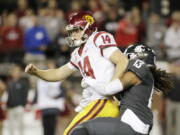 Washington State linebacker Jahad Woods (13) tackles Southern California quarterback Sam Darnold (14) after Darnold fumbles the ball during the second half Friday in Pullman. Washington State won 30-27. Darnold, a Heisman contender, was held to 164 yards passing.