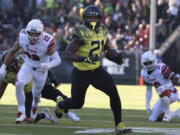 Oregon running back Royce Freeman rushes against Utah's Chase Hansen, left, and Sunia Tauteoli during the second quarter of an NCAA college football game Saturday, Oct. 28, 2017, in Eugene, Ore.