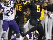 Arizona State quarterback Manny Wilkins (5) spins away from Washington linebacker Connor O’Brien (29) during the first half of an NCAA college football game, Saturday, Oct. 14, 2017, in Tempe, Ariz. (AP Photo/Ross D.