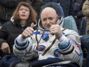 FILE - In this Wednesday, March 2, 2016 photo provided by NASA, International Space Station (ISS) crew member Scott Kelly of the U.S. reacts after landing near the town of Dzhezkazgan, Kazakhstan. In his new autobiography, the retired astronaut writes about his U.S. record-breaking year in space and the challenging life events that got him there.