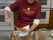 Cheri Bradford dishes up a slice of apple pie at the annual apple festival at Riverside Christian School in Washougal last year.