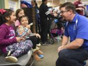 Fruit Valley Principal Matthew Fechter, right, talks to Emily Fargas, 6, from left, Arlet Aparicio, 5, and Giselle Betancourt, 9, while they eat ice cream Oct. 27 at the annual Fall Festival held at Fruit Valley Community Learning Center.