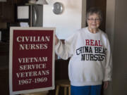 Vietnam War nurse Marion Mullin in her Vancouver home with the sign she carried during the 1993 dedication of the Women’s Vietnam War Memorial in Washington D.C. Her sweatshirt references the 1988-1991 television series — “China Beach” — about nurses during the Vietnam War.