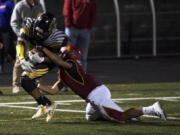 Quadrese Teague (4) of Hudson’s Bay pulls through to the end zone for a touchdown as Prairie’s Izaiah Ward (4) tried to take him down during the 3A GSHL tiebreaker at Doc Harris stadium on Monday night, Oct. 30, 2017. Hudson’s Bay won the tiebreaker 6-3.