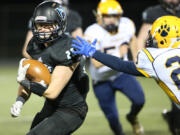 Hockinson Hawks Kyle Nute (25) eludes a tackle against the Aberdeen Bobcats.