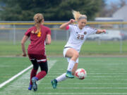 Prairie senior Kaylin Sperley keeps the ball from Capital junior Maddie Thompson during a 3A bi-district playoff game at Prairie High School on Saturday, November 4, 2017. Prairie beat Capital 2-1.