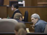 Brent Luyster, right, waits for opening statements to begin in his triple aggravated murder trial in Clark County Superior Court on Nov. 1.