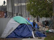 Tents line the sidewalk Monday along West 12th Street as homeless residents camp in Vancouver.