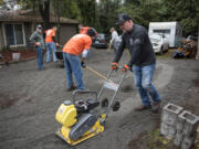 Kleen Street’s Joseph Wild-Talbott and Home Depot volunteers spread gravel at a home in Vancouver.