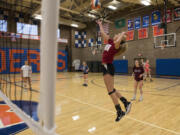 Anika Nicoll spikes the ball during practice at Ridgefield High School as the Spudders get ready for the 2A state tournament this weekend.