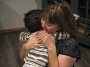 Sheryl Herd hugs her son Karter, 2, as they play in the living room after breakfast Wednesday morning at their home in northeast Vancouver. Karter’s adoption was finalized earlier this month. “I just wish I could encourage more people to do it,” Herd said.