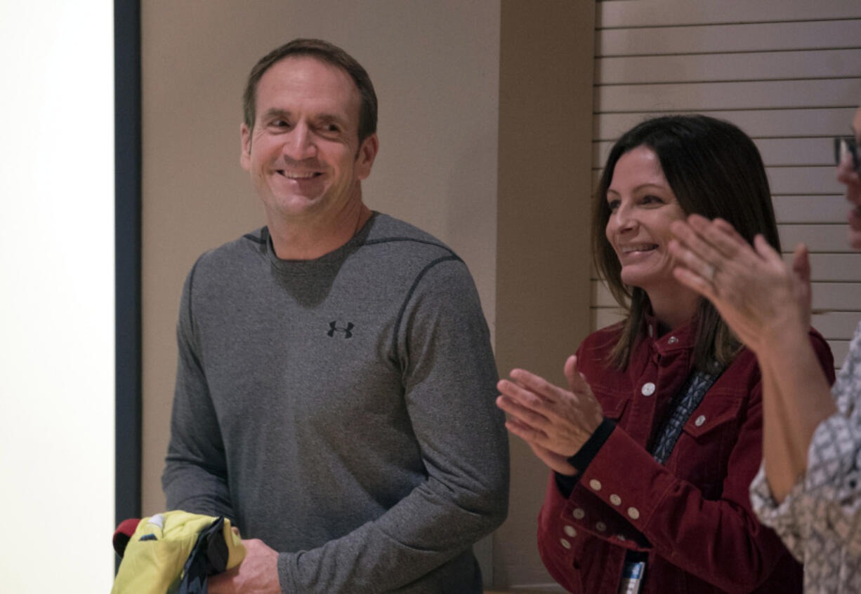 Subway franchise owner Mike Harbold, left, of Vancouver receives applause for donating sandwiches and cookies to the National Adoption Day celebration at First United Methodist Church in Vancouver on Thursday evening.