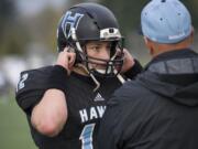 Hockinson’s Cannon Racanelli (12) talks to a coach after scoring a touchdown during the class 2A state playoffs against Pullman at Battle Ground District Stadium, Friday November 10, 2017.