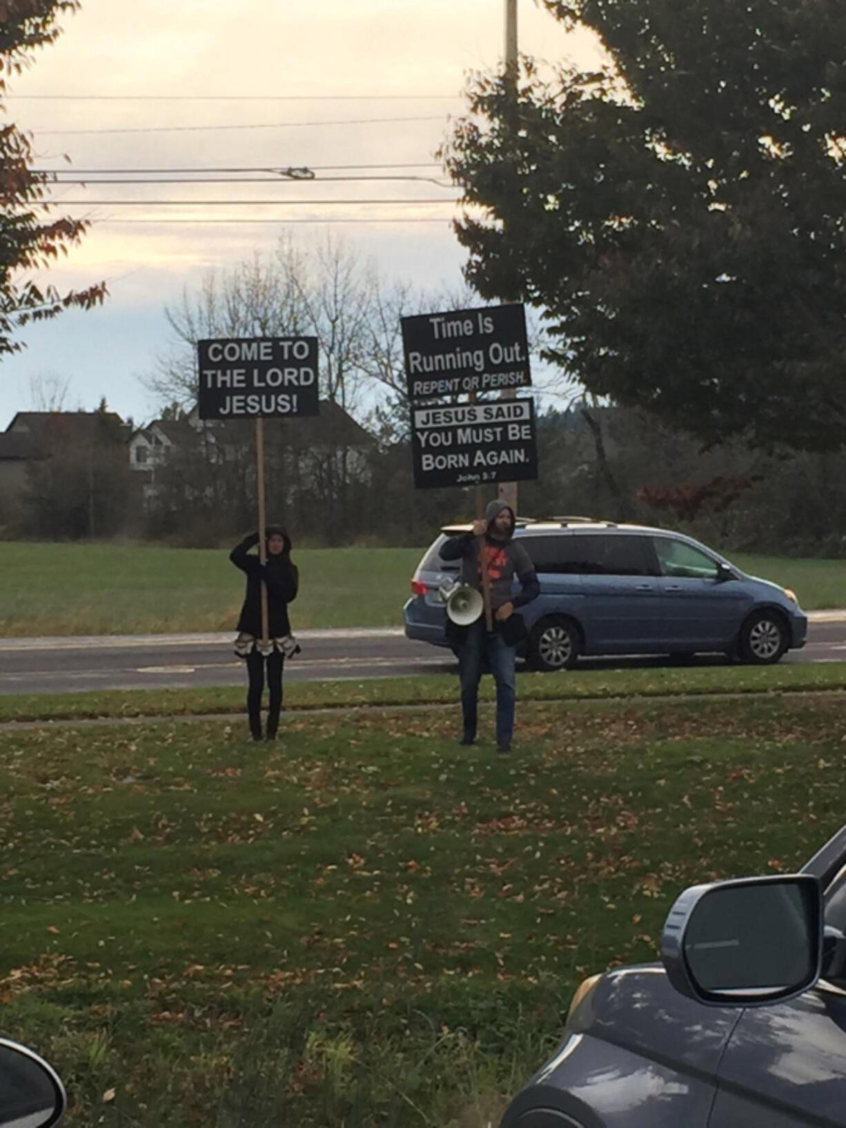 Protesters stand outside Camas High School on Tuesday. They were protesting the school’s production of “The Laramie Project,” which follows the fatal beating of a gay student at the University of Wyoming.