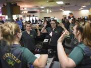 Evergreen bowlers high-five in a circle during the season opening jamboree at Crosley Lanes in Vancouver, Thursday November 9, 2017.